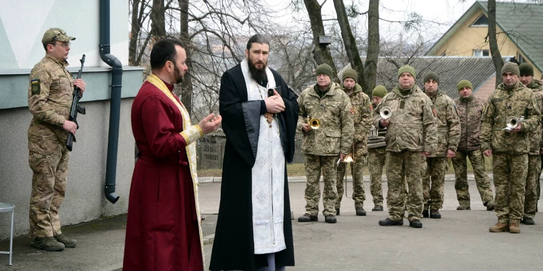 Духовенство й військові беруть участь у відкритті пам'ятної дошки.