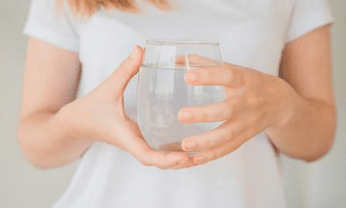 Коли організму бракує води: на що варто звернути увагу Склянка з водою в руках жінки.