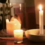 Три запалені свічки на столі.