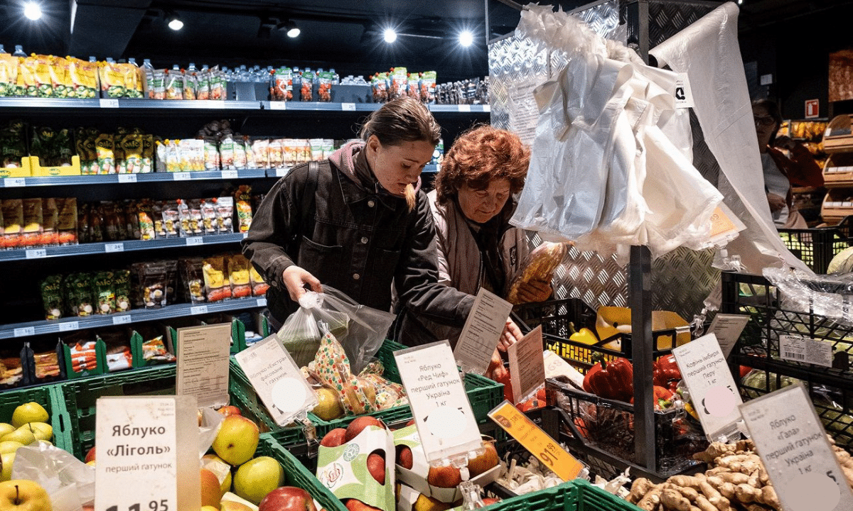 Покупці обирають овочі та фрукти в супермаркеті