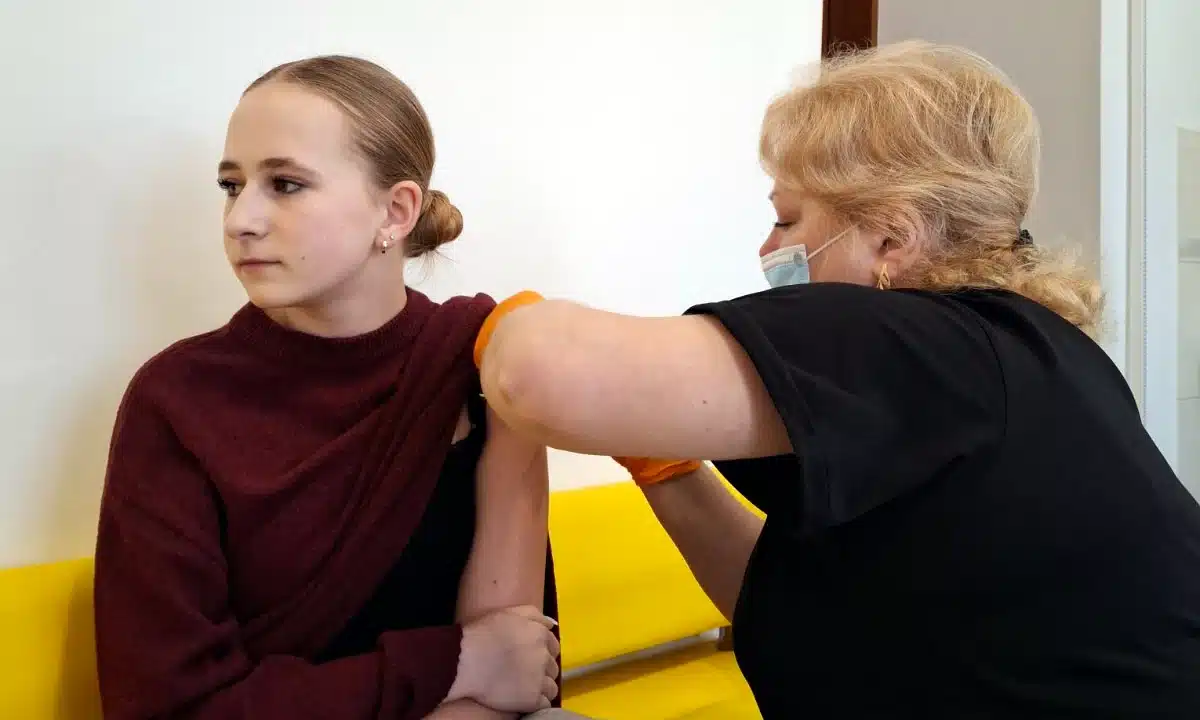 Лікарка вводить вакцину молодій дівчині.